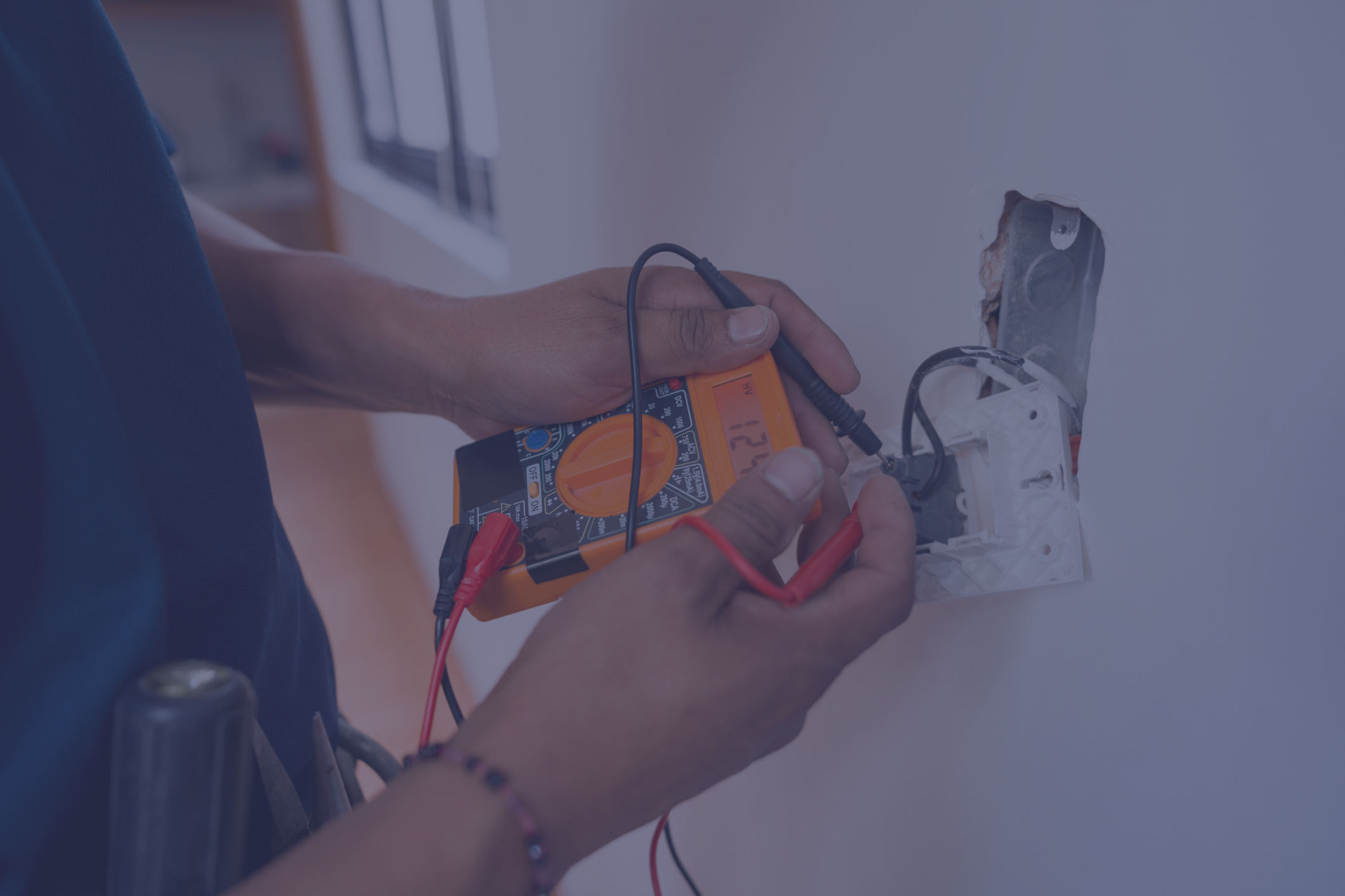 Electrician measuring voltage in home.